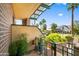 Cozy covered patio with green railing, brick walls, and potted plants at 17 W Vernon Ave # 31, Phoenix, AZ 85003