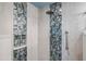 Close-up of a shower with unique tile design and modern fixtures with storage cubby and safety bar at 17 W Vernon Ave # 31, Phoenix, AZ 85003