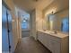 Bathroom with a double sink vanity, tile floors, and modern lighting at 1725 W Pollack St, Phoenix, AZ 85041