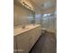 Bathroom featuring a double vanity and glass shower at 1725 W Pollack St, Phoenix, AZ 85041