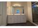 Bathroom featuring a double vanity, a large mirror, and a modern shower at 1725 W Pollack St, Phoenix, AZ 85041