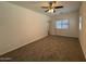 Bright bedroom with carpet, a ceiling fan, and a window with blinds at 1725 W Pollack St, Phoenix, AZ 85041