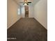 Spacious bedroom featuring plush carpet, a ceiling fan, and an ensuite bathroom at 1725 W Pollack St, Phoenix, AZ 85041