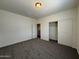 Cozy bedroom with neutral carpet, closet, and light colored walls is move-in ready at 1725 W Pollack St, Phoenix, AZ 85041