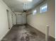 Large two-car garage with bright lighting and windows, plus an automatic door at 1725 W Pollack St, Phoenix, AZ 85041