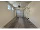 Spacious two-car garage featuring bright lighting, automatic door, and a small window at 1725 W Pollack St, Phoenix, AZ 85041