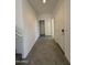 Bright hallway featuring tile flooring, coat closet, and white trim at 1725 W Pollack St, Phoenix, AZ 85041
