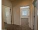 Hallway view with carpet and open doorway to bedrooms with white doors and neutral walls at 1725 W Pollack St, Phoenix, AZ 85041