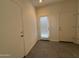 Neutral hallway features tiled floor, an entry door with blinds, and two entry doors at 1725 W Pollack St, Phoenix, AZ 85041