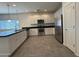 Kitchen with white cabinets, stainless steel appliances, and black countertops at 1725 W Pollack St, Phoenix, AZ 85041