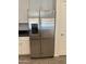 Close-up of stainless steel refrigerator and white cabinets in kitchen at 1725 W Pollack St, Phoenix, AZ 85041