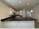 Kitchen with black countertops, white cabinets, pendant lighting, and stainless steel appliances at 1725 W Pollack St, Phoenix, AZ 85041