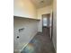 Laundry room with hookups and shelving, leading to backyard access at 1725 W Pollack St, Phoenix, AZ 85041