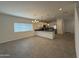 Open-concept living area flows into kitchen with black counters and stainless steel appliances at 1725 W Pollack St, Phoenix, AZ 85041