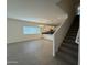 Open concept living room featuring gray tile floors, staircase, and modern lighting at 1725 W Pollack St, Phoenix, AZ 85041