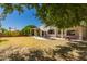 Spacious backyard featuring a patio, seating under an umbrella, and well-maintained landscaping at 1802 W Encinas St, Gilbert, AZ 85233