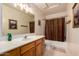 An immaculate bathroom featuring a shower with curtain, updated sink and cabinets at 1802 W Encinas St, Gilbert, AZ 85233