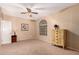 An empty bedroom showcasing neutral colored carpet, a window, and a chest of drawers at 1802 W Encinas St, Gilbert, AZ 85233