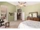 Bright primary bedroom showcasing light green walls, an en-suite bath and walk-in closet at 1802 W Encinas St, Gilbert, AZ 85233