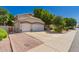 A well-maintained house boasts a three-car garage, desert landscaping, and an American flag at 1802 W Encinas St, Gilbert, AZ 85233