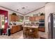 A country style kitchen featuring wood cabinets, an island, and updated appliances at 1802 W Encinas St, Gilbert, AZ 85233
