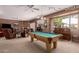 Cozy living room with pool table and large windows at 1802 W Encinas St, Gilbert, AZ 85233