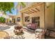 Covered patio includes an outdoor swing, firepit and patio furniture, providing relaxation and entertainment at 1802 W Encinas St, Gilbert, AZ 85233