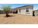 Low maintenance backyard featuring a gravel landscape, covered patio, and desert foliage at 18711 W Farmer Rd Rd, Buckeye, AZ 85326