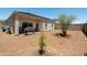 Gravel backyard with covered patio, solar panels, landscaping and grill, perfect for outdoor entertaining at 18711 W Farmer Rd Rd, Buckeye, AZ 85326