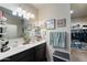 Bathroom boasts double sinks, granite counters, framed art, and a walk-in closet at 18711 W Farmer Rd Rd, Buckeye, AZ 85326
