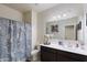 Functional bathroom with a shower, a dark vanity, and a wide mirror at 18711 W Farmer Rd Rd, Buckeye, AZ 85326
