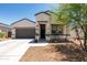 Charming single-story home featuring a low-maintenance front yard and a welcoming entryway at 18711 W Farmer Rd Rd, Buckeye, AZ 85326