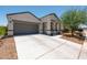 Lovely single-story home with a spacious driveway, desert landscaping, and modern architectural design at 18711 W Farmer Rd Rd, Buckeye, AZ 85326