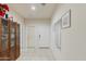 Hallway featuring wood-look display cabinet and a combination of doors and mirrors at 18711 W Farmer Rd Rd, Buckeye, AZ 85326