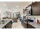 Spacious kitchen featuring a kitchen island and black appliances with an open view into the living room at 18711 W Farmer Rd Rd, Buckeye, AZ 85326
