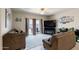 Cozy living room featuring comfortable couches, a large TV, and sliding doors to the outdoor area at 18711 W Farmer Rd Rd, Buckeye, AZ 85326
