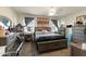 Cozy main bedroom featuring a large bed with grey bedding, dresser, and window with drapes at 18711 W Farmer Rd Rd, Buckeye, AZ 85326