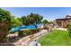 Scenic backyard view with lush landscaping and a tranquil pond at 19822 N 108Th Ave, Peoria, AZ 85373