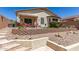 Landscaped backyard with stone accents, tiered walls, and patio area at 19822 N 108Th Ave, Peoria, AZ 85373