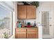 Convenient bar nook area with wooden cabinets providing additional counter space and storage at 19822 N 108Th Ave, Peoria, AZ 85373