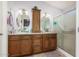 Bathroom featuring double vanity with granite counters and walk-in shower at 19822 N 108Th Ave, Peoria, AZ 85373