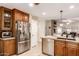 Open kitchen featuring stainless steel refrigerator, ample cabinets, granite counters, and pantry at 19822 N 108Th Ave, Peoria, AZ 85373