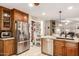 Open kitchen featuring stainless steel refrigerator, ample cabinets, and granite counters at 19822 N 108Th Ave, Peoria, AZ 85373
