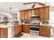 Spacious kitchen with stainless steel appliances, granite countertops, and mosaic backsplash at 19822 N 108Th Ave, Peoria, AZ 85373