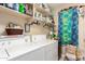 Functional laundry room with washer, dryer, and ample shelving for storage at 19822 N 108Th Ave, Peoria, AZ 85373