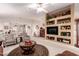 Bright living room with an open floor plan, stylish furniture, and decorative built-in shelving at 19822 N 108Th Ave, Peoria, AZ 85373