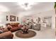 Spacious living room showcasing a cozy seating arrangement, ceiling fan, and open layout at 19822 N 108Th Ave, Peoria, AZ 85373