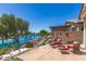 Waterfront patio featuring lounge chairs, and scenic lake views, perfect for relaxing and outdoor enjoyment at 19822 N 108Th Ave, Peoria, AZ 85373