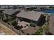 Aerial view of the backyard with a patio, firepit, and serene water views at 20211 N Winter Escape Ct, Maricopa, AZ 85138