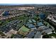 Bird's eye view of community tennis courts, putting greens, parking, and neighborhood at 20211 N Winter Escape Ct, Maricopa, AZ 85138